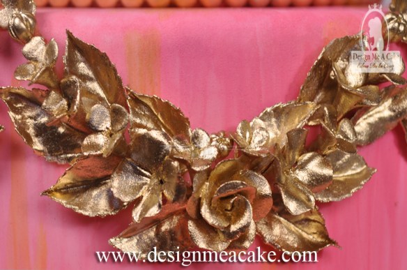 Gold swag of gumpaste flowers.